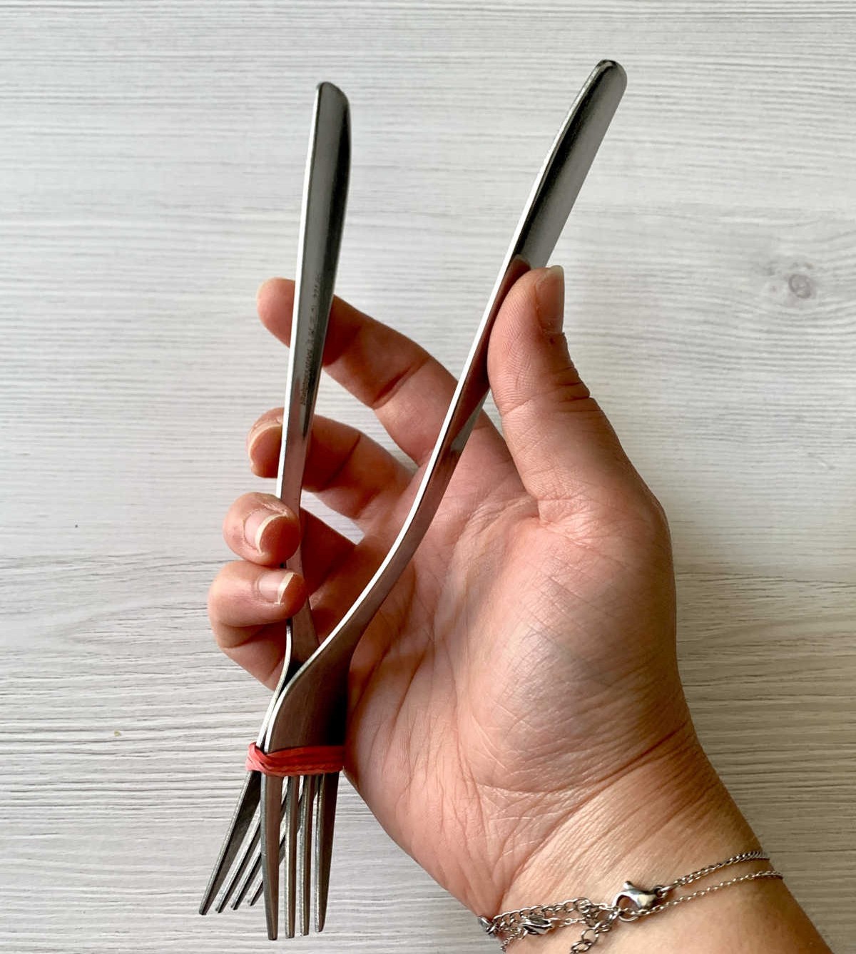Tie Two Forks Together with a Rubber Band to Make a Pair of Tong