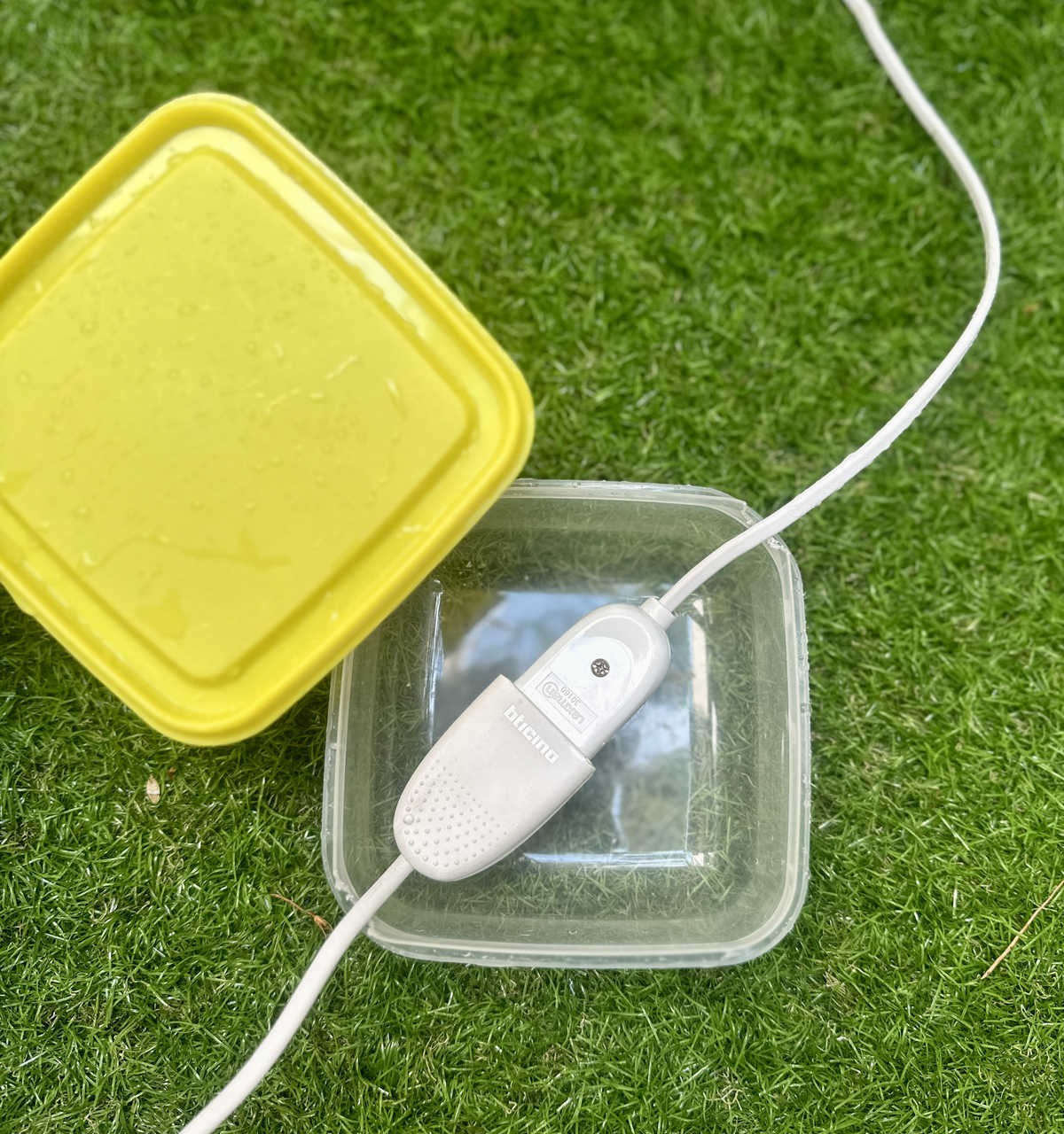 Cut the Corner of a Tupperware to Shelter Plugs From the Rain