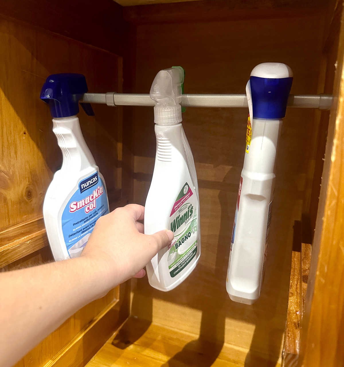 Use a Tension Rod to Hang Spray Bottles